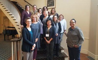 Team members standing on the stairs posing for the picture